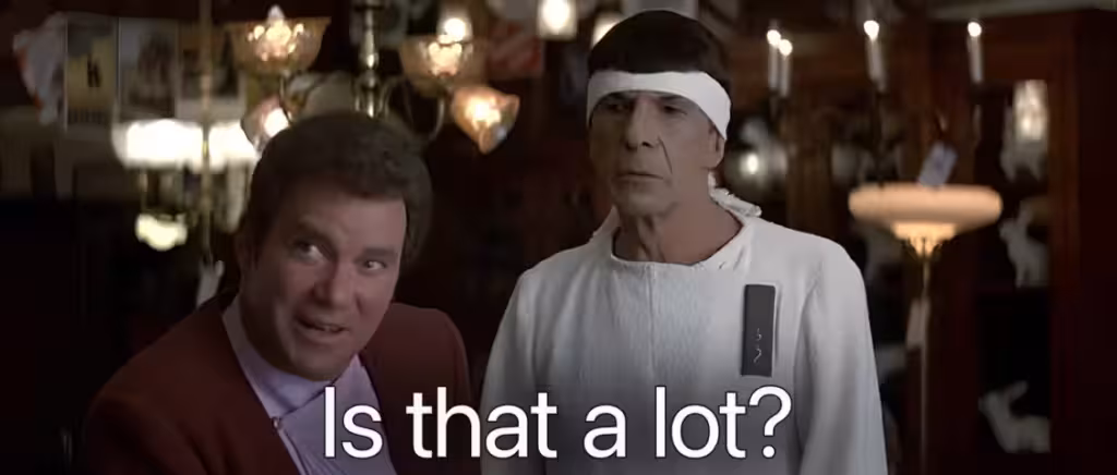 Still image of the pawn shop scene from Star Trek IV (The Voyage Home) showing Kirk & Spock responding to the offer of $100 for the antique spectacles with "Is that a lot?".